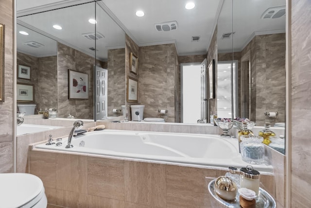 bathroom with a relaxing tiled tub, crown molding, and toilet