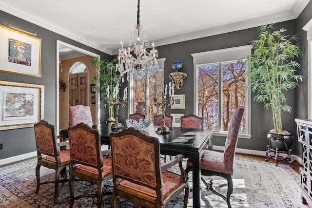 dining space with ornamental molding, wood-type flooring, and a notable chandelier