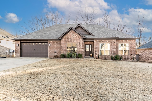 view of front of home featuring a garage and a front lawn