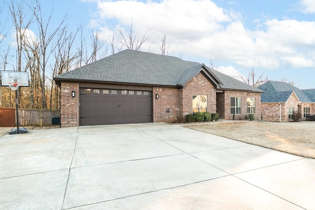 view of front of home with a garage and central AC unit