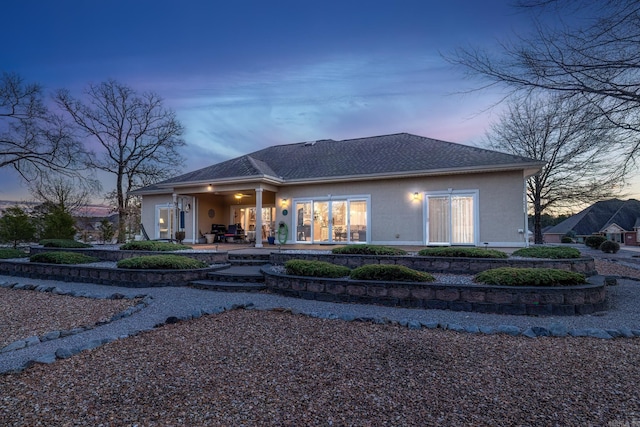 back house at dusk with a patio