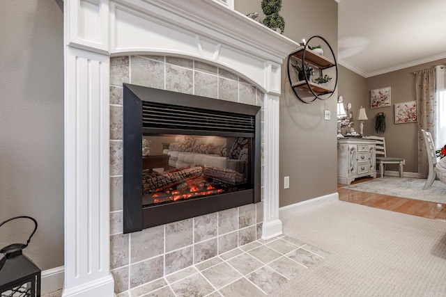 details with a tiled fireplace, ornamental molding, decorative columns, and carpet flooring