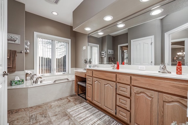 bathroom featuring vanity and a washtub