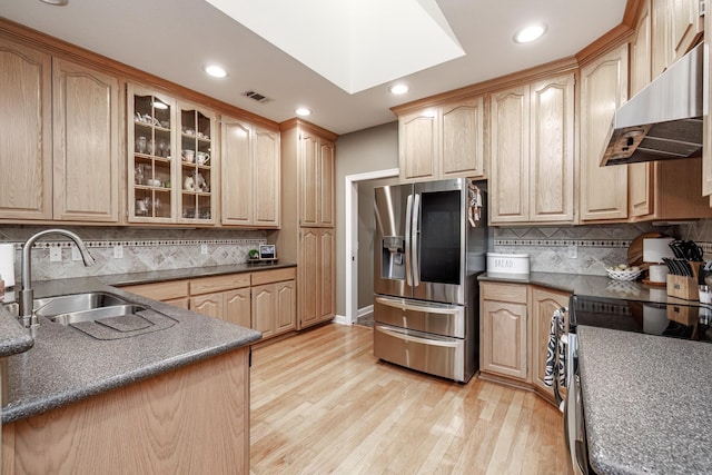 kitchen featuring stainless steel appliances, sink, and light brown cabinets