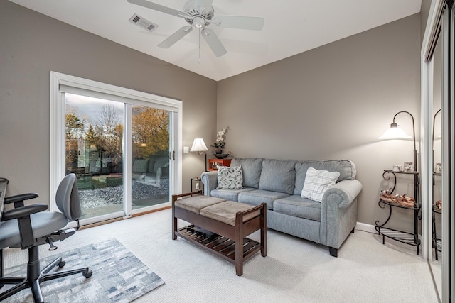 carpeted living room with ceiling fan