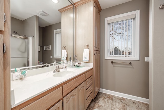 bathroom with vanity and a shower with shower door