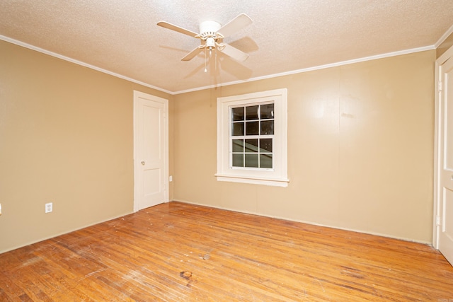 spare room with ceiling fan, ornamental molding, a textured ceiling, and light wood-type flooring