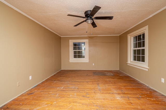 spare room featuring crown molding, a textured ceiling, ceiling fan, and light wood-type flooring