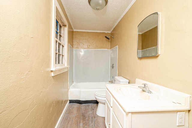 full bathroom featuring toilet, crown molding, wood-type flooring, a textured ceiling, and vanity