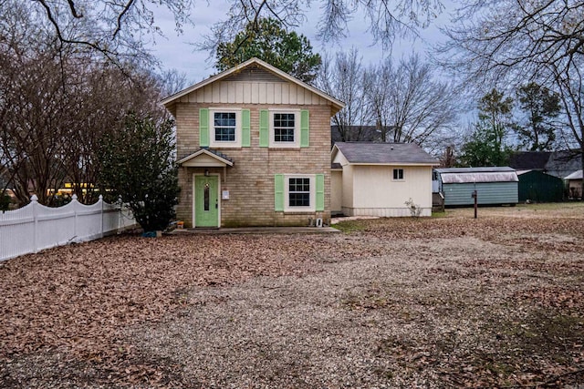 view of front of home with a shed