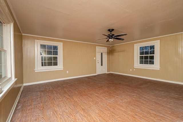 spare room with hardwood / wood-style flooring, ceiling fan, and crown molding