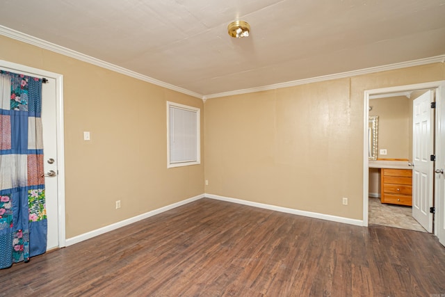 empty room with crown molding, dark hardwood / wood-style flooring, and built in desk