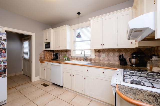 kitchen featuring sink, white appliances, range hood, white cabinets, and decorative light fixtures