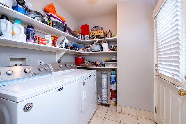 clothes washing area featuring independent washer and dryer and light tile patterned floors