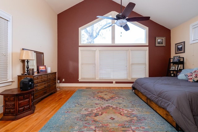 bedroom featuring high vaulted ceiling, ceiling fan, and light wood-type flooring