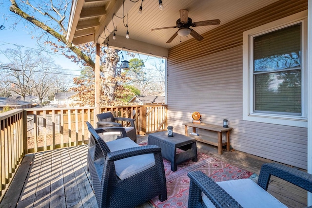 deck with ceiling fan and an outdoor living space