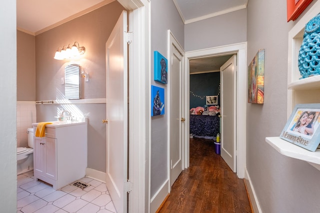 bathroom featuring vanity, ornamental molding, and toilet