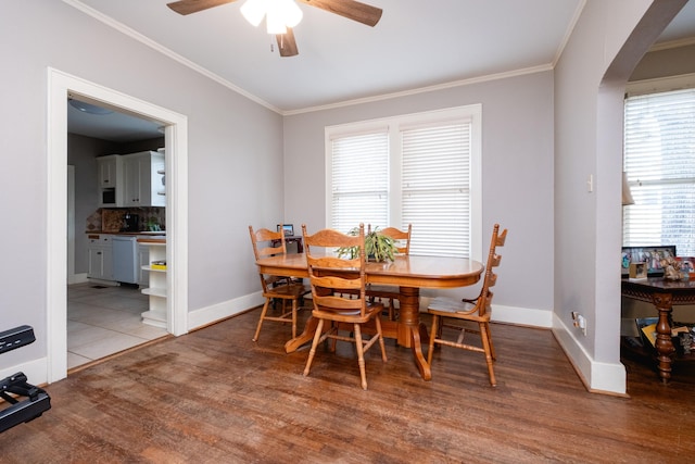 dining room with crown molding, wood-type flooring, and a wealth of natural light