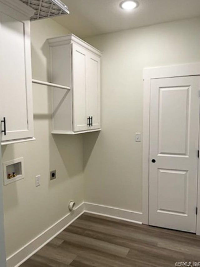 clothes washing area with cabinets, electric dryer hookup, dark wood-type flooring, and washer hookup