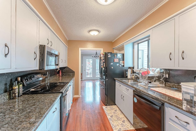 kitchen featuring dark stone counters, white cabinets, dark hardwood / wood-style flooring, and black appliances