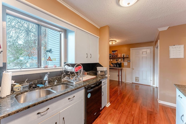 kitchen featuring white cabinetry, black dishwasher, a textured ceiling, and dark stone counters