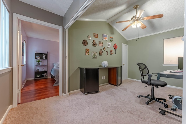 office area featuring light carpet, crown molding, vaulted ceiling, and a textured ceiling