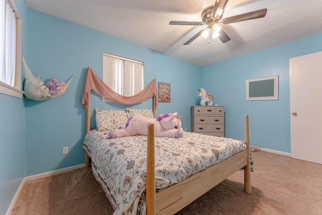 bedroom featuring carpet floors, a textured ceiling, and ceiling fan