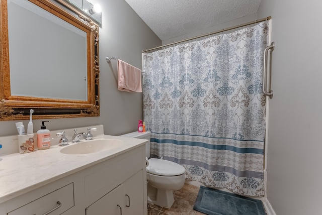 bathroom featuring tile patterned flooring, vanity, a textured ceiling, and toilet