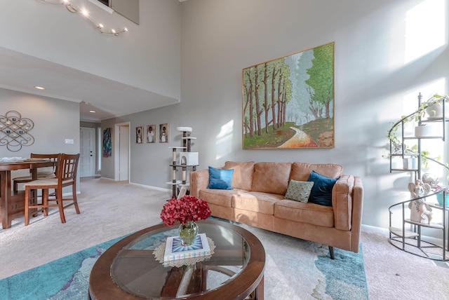 carpeted living room with a high ceiling