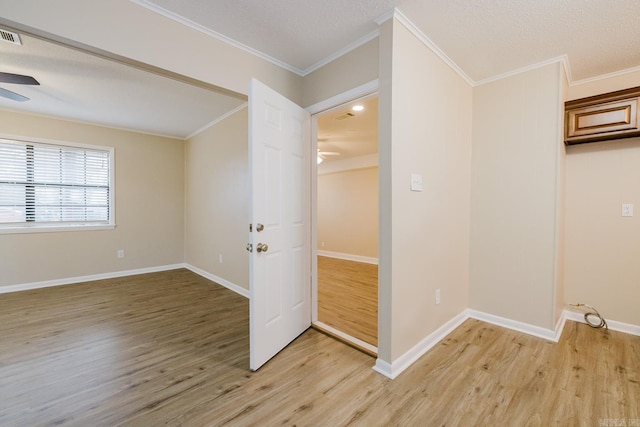 interior space with hardwood / wood-style flooring, ceiling fan, crown molding, and a textured ceiling