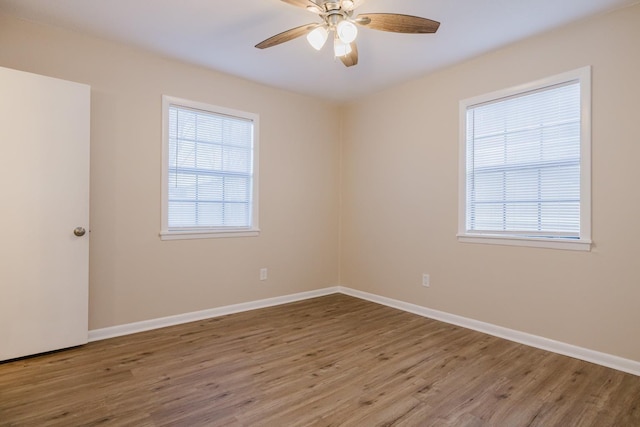 unfurnished room featuring hardwood / wood-style floors and ceiling fan