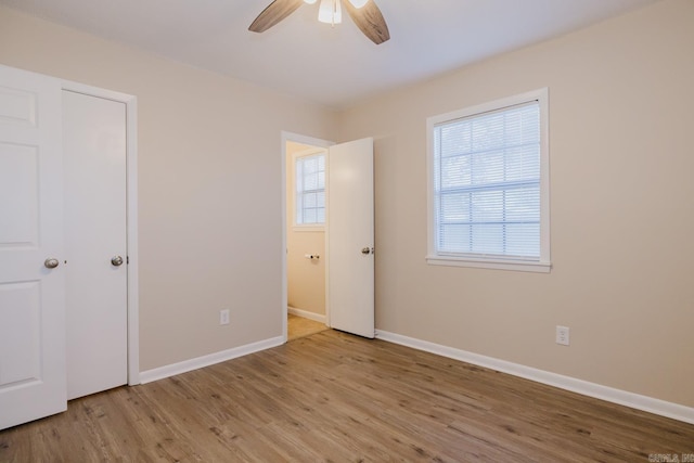 unfurnished bedroom featuring ceiling fan and light wood-type flooring