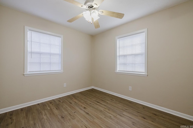 spare room with hardwood / wood-style floors and ceiling fan