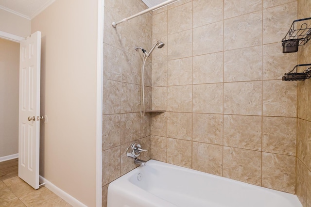 bathroom featuring tile patterned flooring and tiled shower / bath