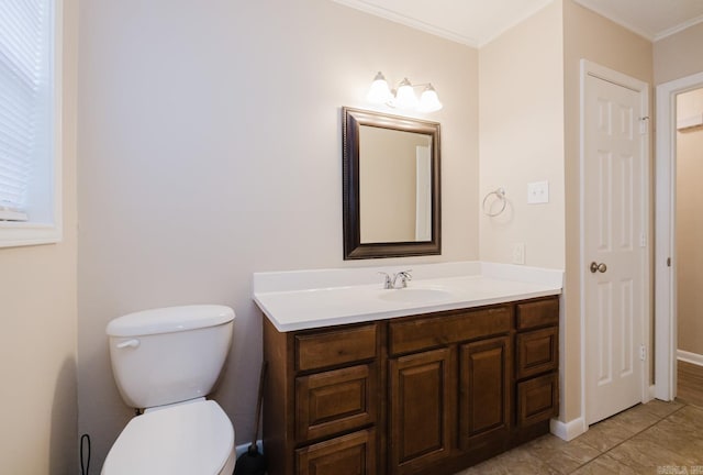 bathroom with ornamental molding, toilet, tile patterned flooring, and vanity