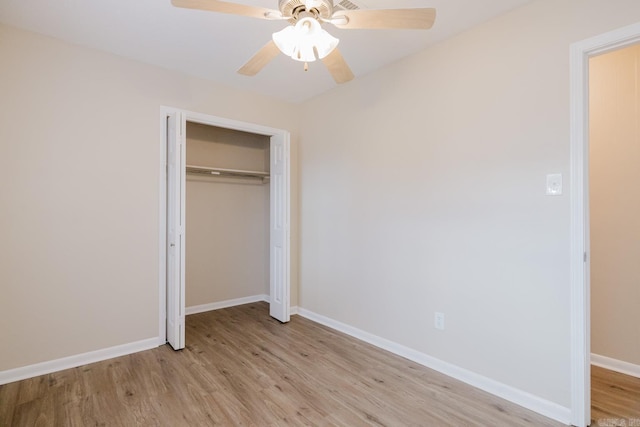 unfurnished bedroom featuring light hardwood / wood-style flooring, ceiling fan, and a closet