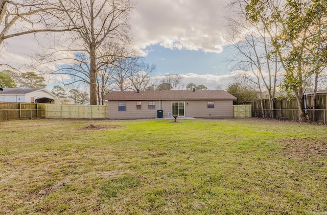 rear view of house featuring a yard