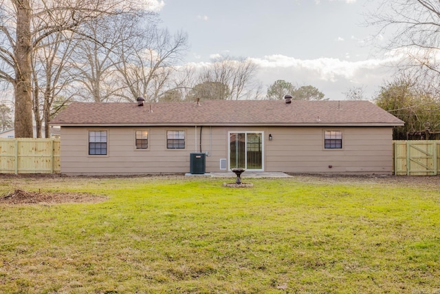 back of house featuring central AC and a lawn