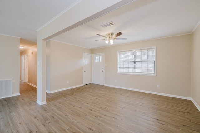 empty room featuring ceiling fan, ornamental molding, and light hardwood / wood-style floors