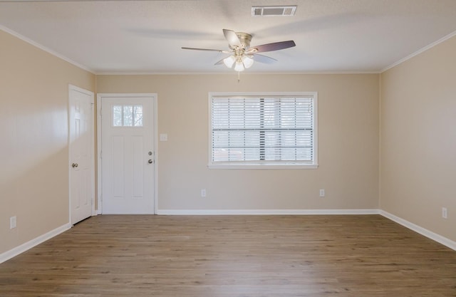 entrance foyer with ceiling fan, ornamental molding, and hardwood / wood-style floors