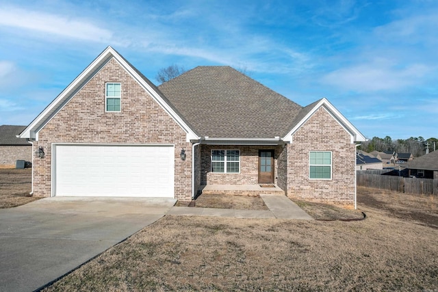 view of front of house featuring a garage and a front lawn