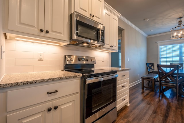 kitchen with white cabinetry, tasteful backsplash, crown molding, decorative light fixtures, and appliances with stainless steel finishes