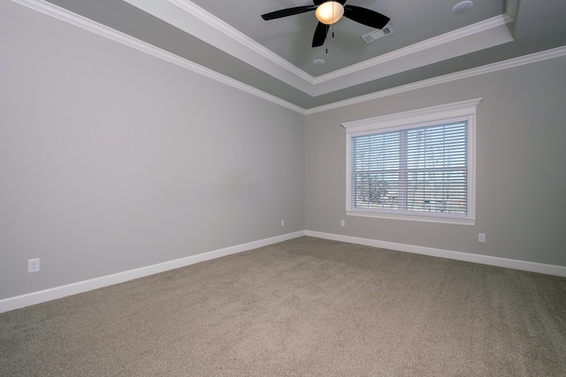 spare room with crown molding, ceiling fan, a raised ceiling, and carpet floors