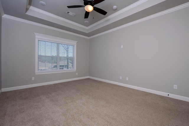 carpeted empty room featuring ornamental molding, a raised ceiling, and ceiling fan