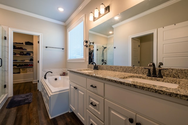 bathroom featuring vanity, hardwood / wood-style floors, ornamental molding, and independent shower and bath