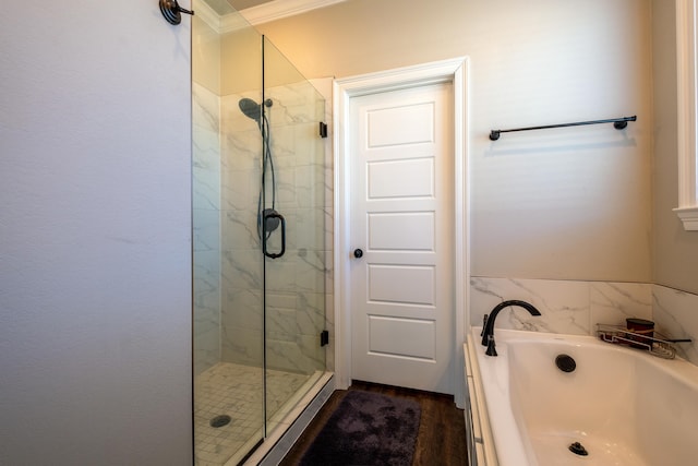 bathroom with independent shower and bath, ornamental molding, and hardwood / wood-style flooring