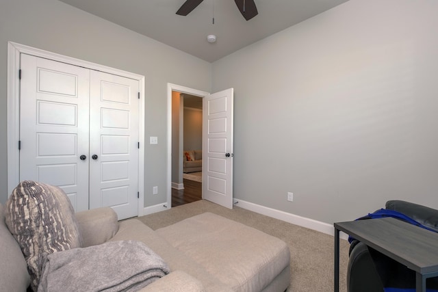 carpeted bedroom featuring ceiling fan and a closet