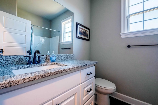 bathroom featuring vanity, toilet, and a shower with shower curtain