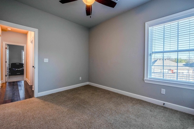 carpeted spare room with ceiling fan