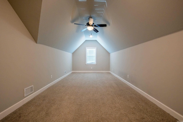 additional living space featuring lofted ceiling and carpet